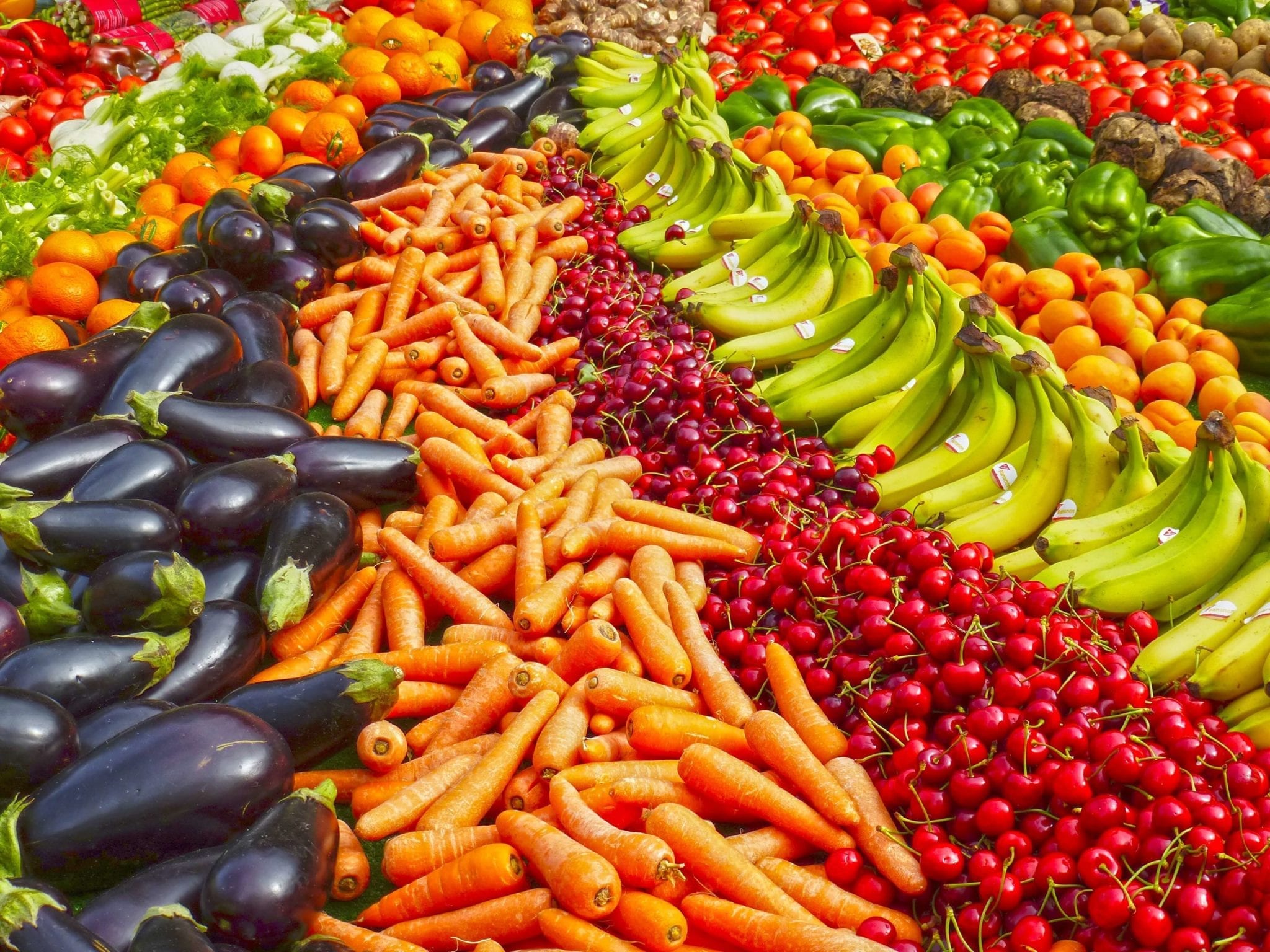 Rows of eggplants, carrots, cherries, bananas, and other fruits & vegetables