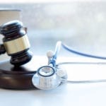A gavel and a stethoscope. Nursing home abuse concept photo.