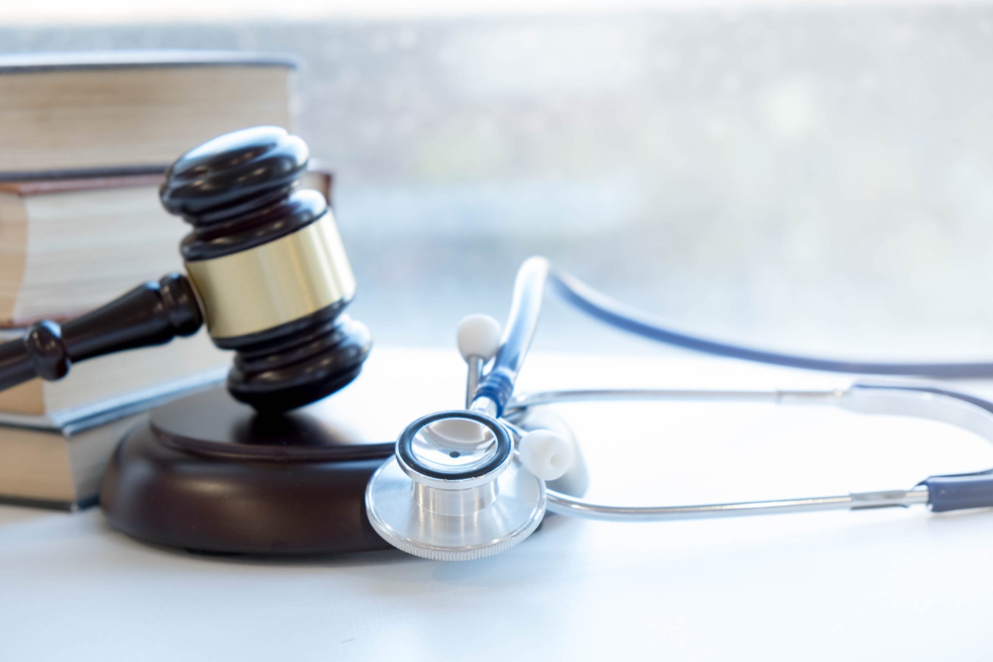A gavel and a stethoscope. Nursing home abuse concept photo.