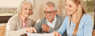 young woman sitting at table with two elderly people