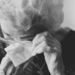 black and white photo of elderly woman crying