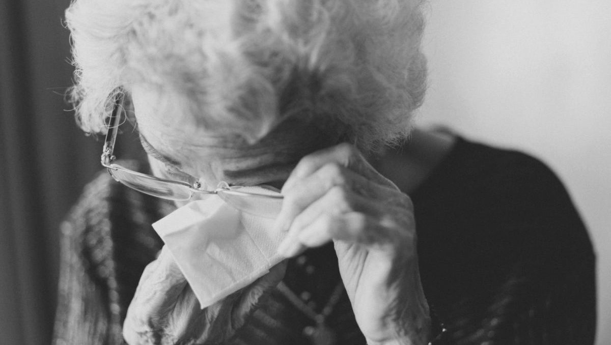 black and white photo of elderly woman crying