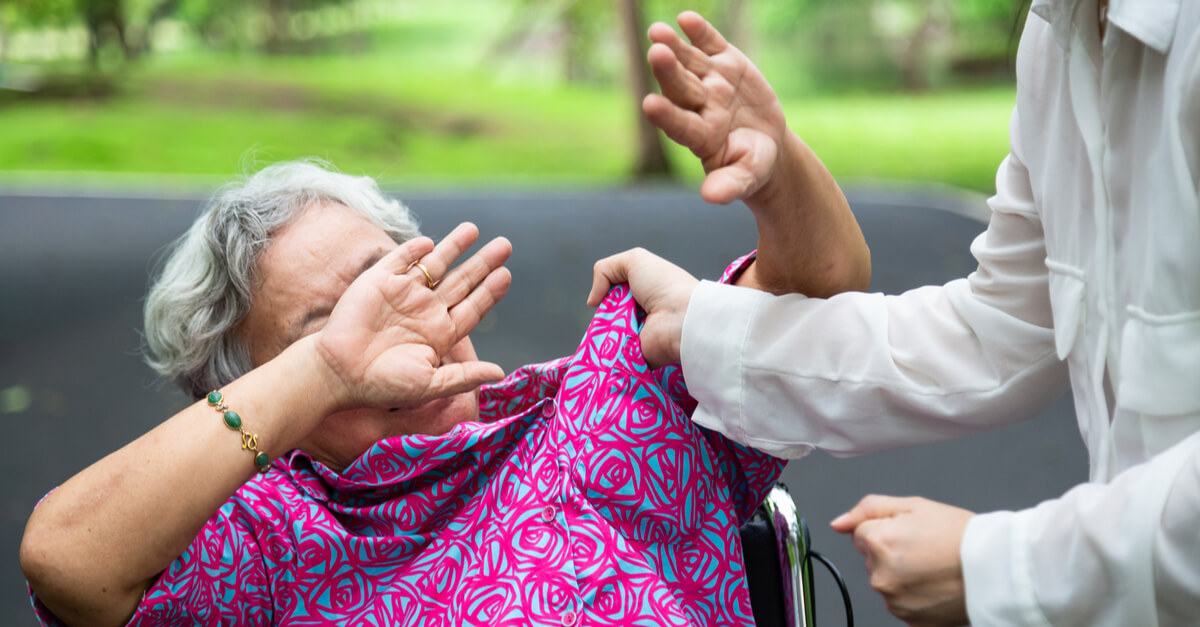 an older woman about to get hit by a man