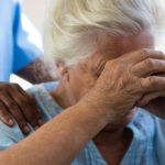 elderly woman at nursing home being pushed in a wheelchair