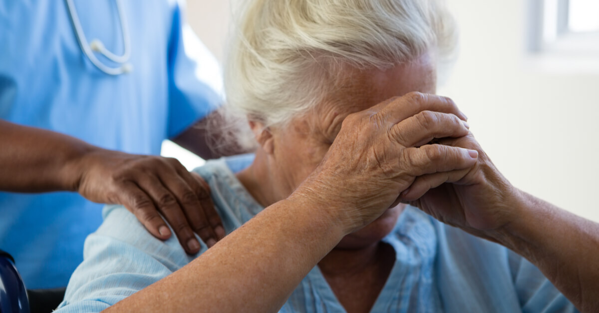 elderly woman at nursing home being pushed in a wheelchair