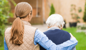 Woman visiting a loved one in a nursing home.