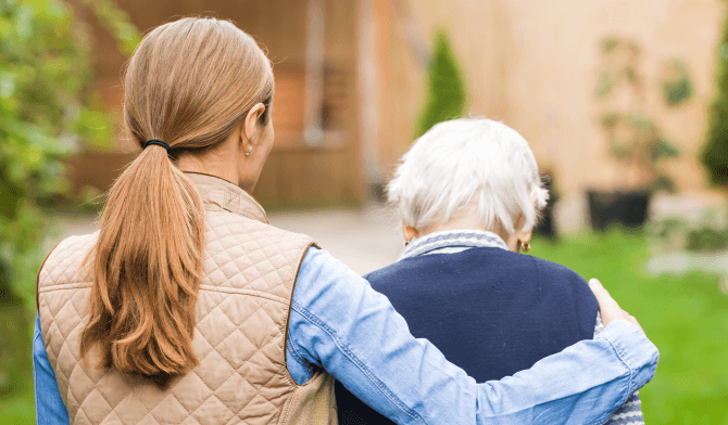 daughter helping elderly father walk