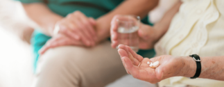 Patient holds medications in hand