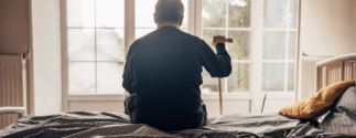 Nursing home resident alone looking out window