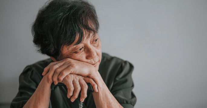 Woman rests on cane