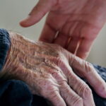 Hand reaching for an older person