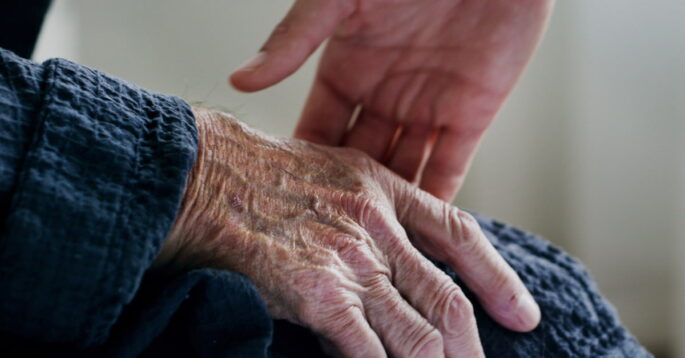 Hand reaching for an older person