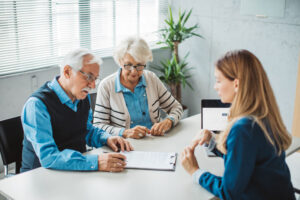 An older couple meets with a lawyer to get nursing home legal advice.