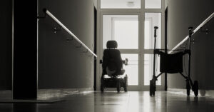 An empty hallway with a wheelchair and walker, representing nursing home elopement.