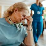A nursing home resident looking distressed, showing the emotional toll of being forced to leave a care facility
